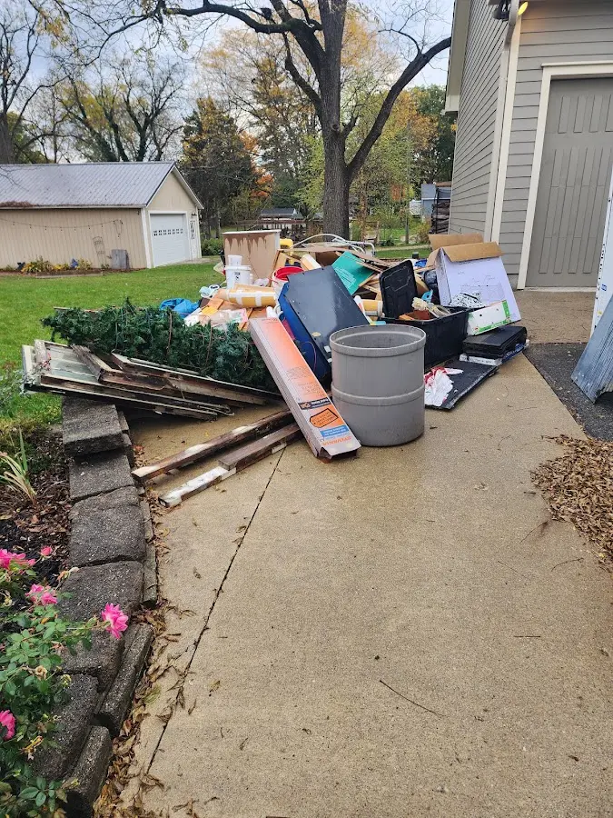 Dumpster being loaded with debris for Residential Dumpster Rental in Macon